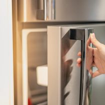 istockphoto-1309860559-170667a Female hand opening a refrigerator door for find the food and ingredient preparing to cooking in their home.